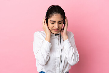 Young telemarketer over isolated background frustrated and covering ears
