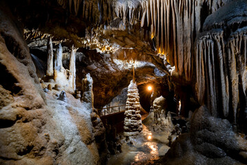 The “Kaiserhalle“ is a famous attraction in the “Dechenhoehle“ (Dechen Cave) in Iserlohn Sauerland Germany. The public show cave with colorful stalactites and stalagmites is  popular touristical sight - obrazy, fototapety, plakaty