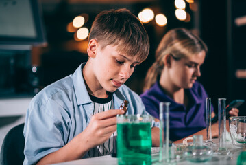 Cheerful teenage students studying in chemical lab test, Classroom learning and education concept