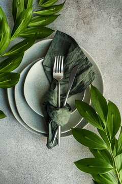 Overhead view of a place setting with ruscus branches
