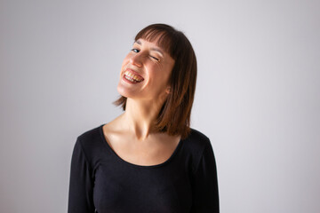 Obraz premium Portrait of a girl on white background. Brown short hair girl. Content girl winking