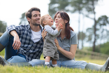 happy young family spending time together outside in green nature