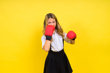 Little girl wearing red boxing gloves, studio shot, sport concept