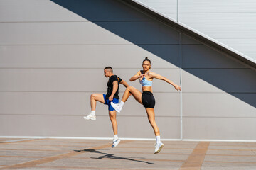Fototapeta na wymiar Couple jumping. Warming up before training
