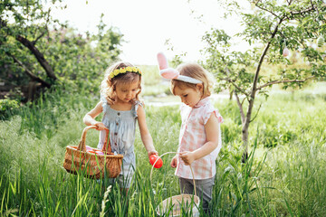 Easter egg hunt. Group Of Children Wearing Bunny Ears Running To Pick Up colorful Egg On Easter Egg...
