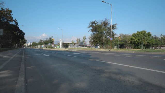 Police car with rotating lights passing the street