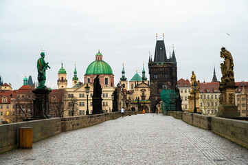 Fototapeta na wymiar Prague, Czech Republic. Charles Bridge with its statuette, Lesser Town Bridge Tower and the tower of the Judith Bridge. 