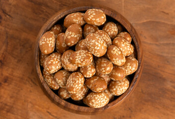 Bowl of Crunchy Asian Sesame Peanuts with Soy Sauce on a Wooden Counter