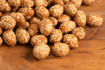 A Pile of Crunchy Asian Sesame Peanuts with Soy Sauce on a Wooden Counter