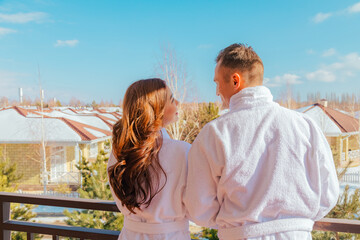 Couple in robes standing during honeymoon