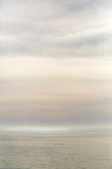 Abstract Dreamy Pastel Clouds and Shimmering Sea at Sunset