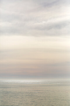 Abstract Dreamy Pastel Clouds and Shimmering Sea at Sunset