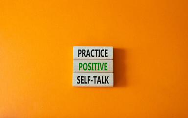 Practice positive self-talk symbol. Concept words Practice positive self-talk on wooden blocks. Beautiful orange background. Business and Practice positive self-talk concept. Copy space