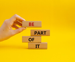 Be part of it symbol. Concept words Be part of it on wooden blocks. Beautiful yellow background. Businessman hand. Business and Be part of it concept. Copy space.