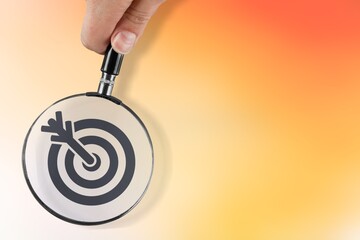 Magnifier glass focuses on image of target icon.