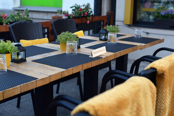 The decor of the restaurant on the street. Laid table