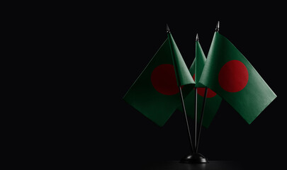 Small national flags of the Bangladesh on a black background