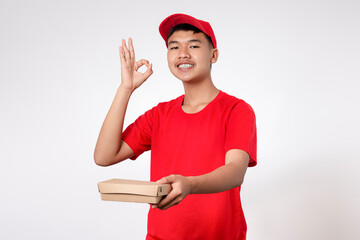 Courier Delivery worker shipping concept. Smiling young asian Delivery man in red uniform isolated on white background deliver lunchbox to the customer, Takeaway food delivery service.