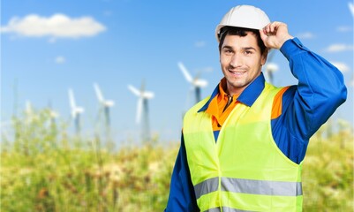 Engineer working at windmill farm, clean energy concept