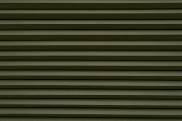 Roller blinds on the window. The texture of roller blinds. Background of stripes
