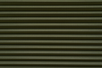 Roller blinds on the window. The texture of roller blinds. Background of stripes