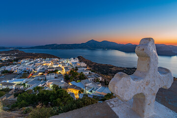 Panoramic view of the bay and Plaka village from the Venetian castle at dusk, Milos island GR