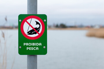 Portuguese fishing prohibited sign near lake - NO FISHING