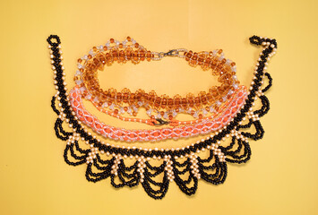 Beads, Jewelery, beads necklace on yellow background. 