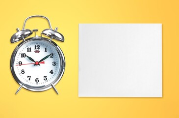 Fototapeta na wymiar Blank office calendar or planner and alarm clock