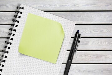 Blank sticky notes on notebook and pen