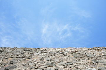 Blue cloudy sky clouds on roof or stone wall background. natural backdrop.