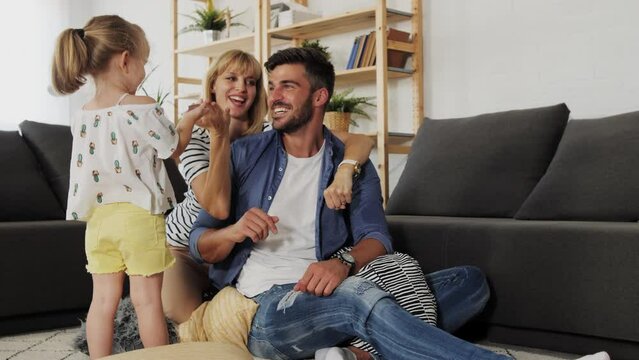 Little girl playing guessing game with parents