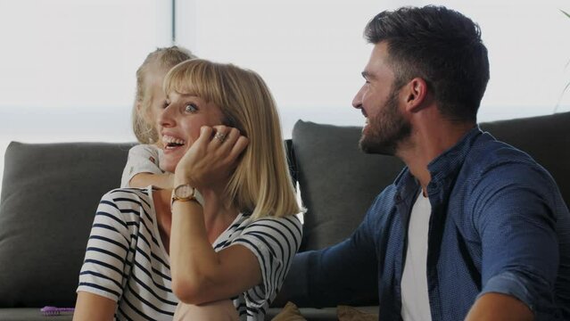 Cute girl combing mom's hair