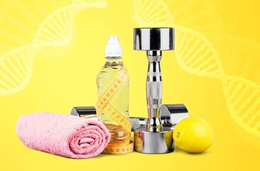 DNA structure, sport dumbbells and tape measure on desk