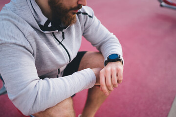 Man checking notifications on smart watch during outdoor training