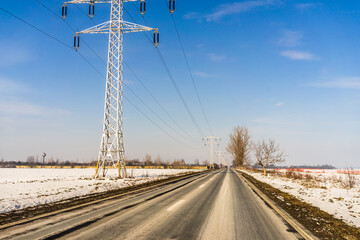 Winter season, view of cars and snowy street through windshield while driving in Bucharest, Romania, 2021.