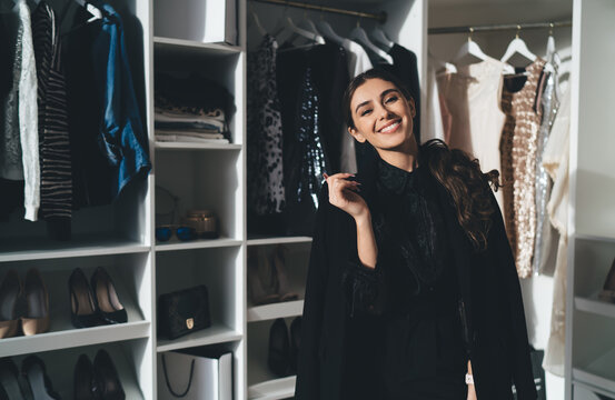 Smiling stylish woman in wardrobe