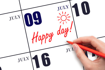 Hand writing the text HAPPY DAY and drawing the sun on the calendar date July 9