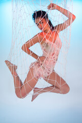 Beautiful girl imprisoned and caught in a net