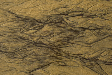 Natural texture of sand. Abstract beautiful drawings on the sand. Paintings in the sand

