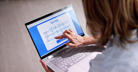 Woman Looking At Online Computer Survey