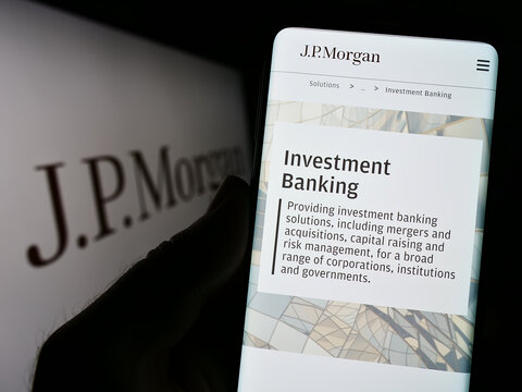 Stuttgart, Germany - 01-30-2023: Person holding smartphone with website of US financial services company J.P. Morgan Co. on screen with logo. Focus on center of phone display.