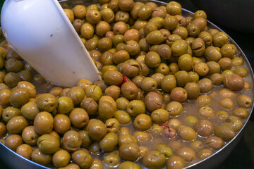 Stand of olives in bulk close-up of green olives