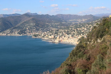 Obraz premium Camogli, Italy - January 28, 2023: An aerial view to the city of Camogli. Beautiful landscape from the ligurian sea with blue sky and mountains in the background. 