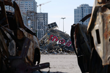 Fototapeta premium Russian missile destroyed cars and shopping center Retroville in Kyiv, Ukraine