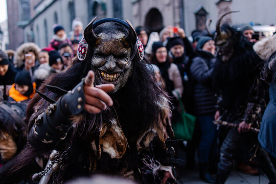 Procession of the Krampus Bavarian tradition in Germany. Costume parade fashing procession. Scary demon make-up with horns for halloween. Zombie parade. Terrible scary masks. Folk German folklore