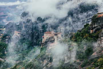 Fototapeta na wymiar A monastery on the rocky mountains hidden in the mist