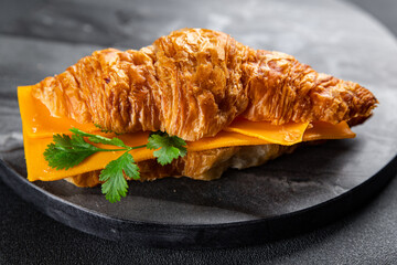 sandwich croissant with cheese fast food takeaway meal food snack on the table copy space food background rustic top view