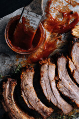 Fototapeta na wymiar American cuisine concept. Grilled pork ribs with grilled sauce. American bbq ribs closeup. wood Dark background.