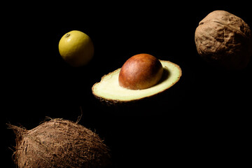 Avocado, Coconut, Walnut, lemon looks like a planet hanging in space © Mykola